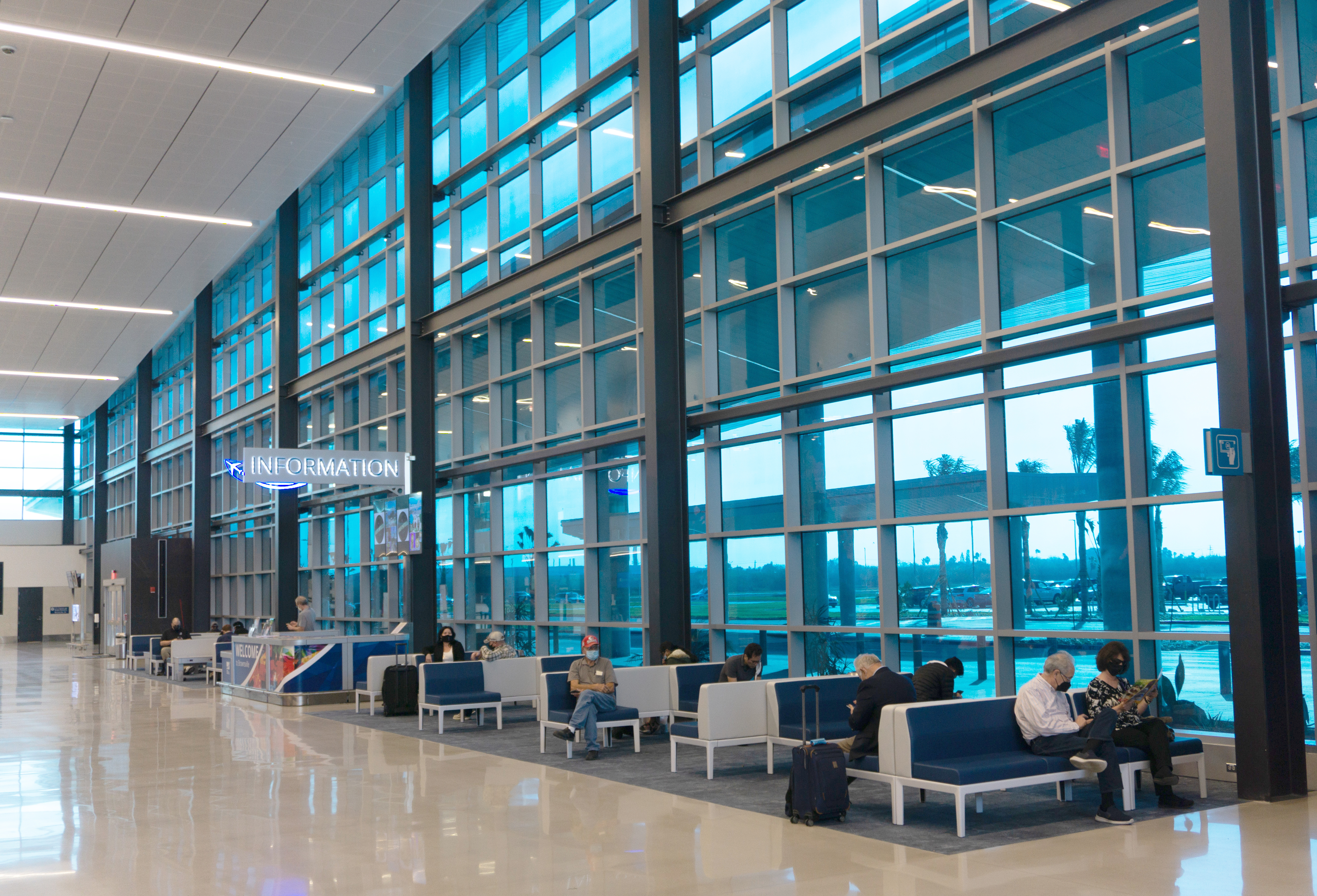 Interior of airport building at gate with custom smart glass windows. 