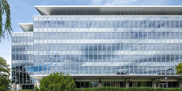 Exterior of a modern all-glass 6 story building. 
