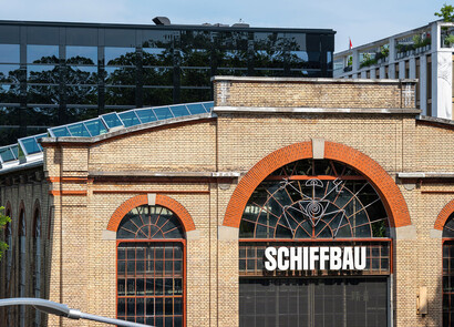 Exterior of Schiffbau building with custom rounded smart glass windows. 