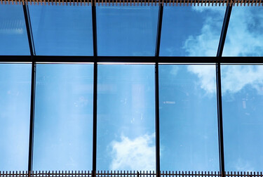 Blue skies seen through windows as viewed from below