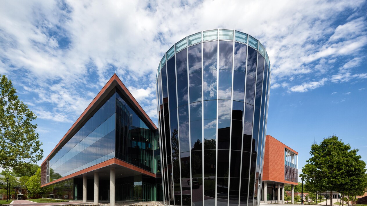 Exterior of unique shaped sharp and rounded buildings with custom smart glass windows.