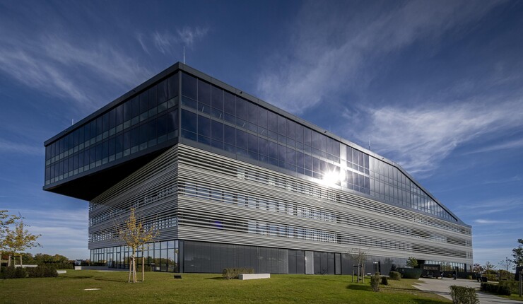 Exterior view of a mostly glass building on a sunny day