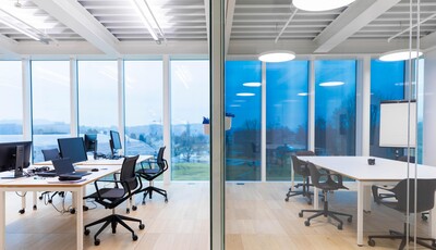 Collaborative office space with smart glass windows from left to right. 
