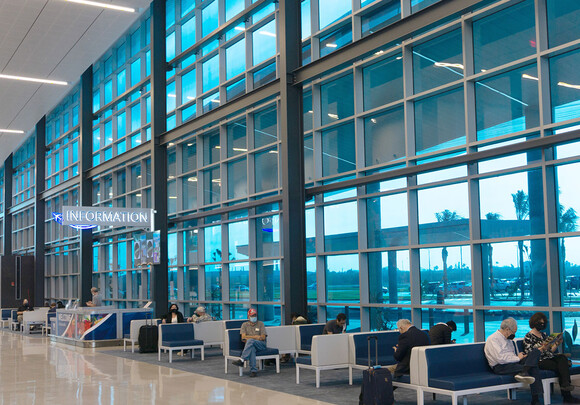 Interior of airport building at gate with custom smart glass windows. 