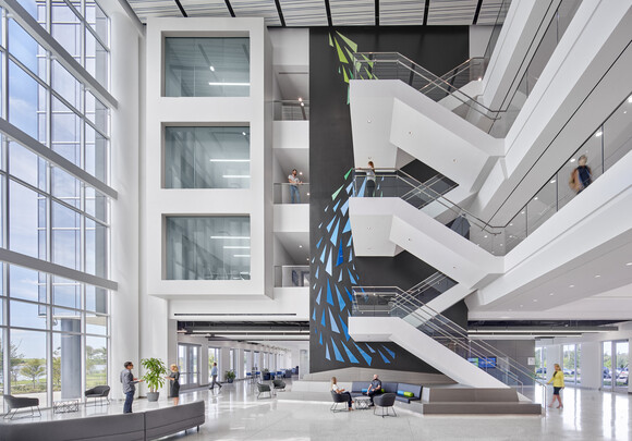 Image of soaring 4-story atrium which includes open staircases and lobby space 