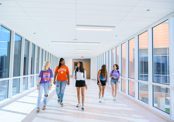 Students travel through light-filled skyway between Daniel Hall wings.