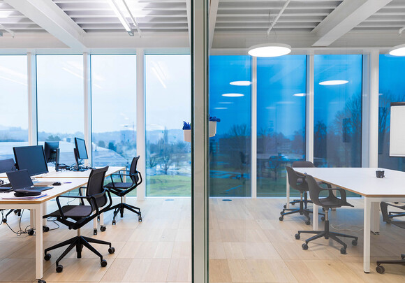 Interior office space of an modern smart glass building with large windows.