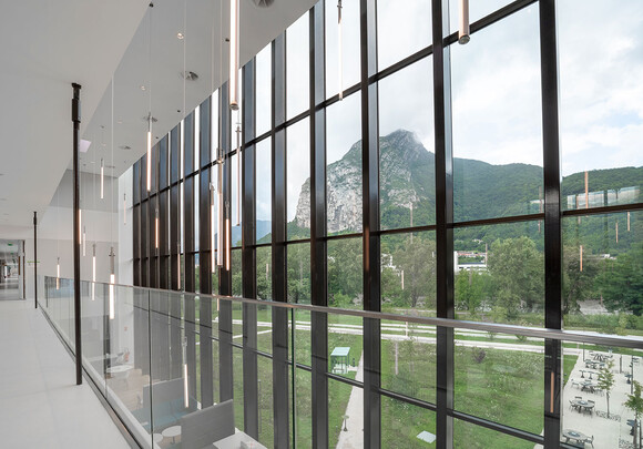 Hallway in modern glass building with smart glass windows.
