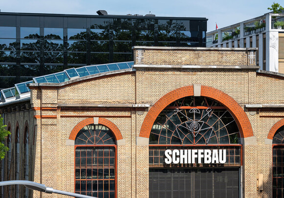 Exterior of Schiffbau building with custom rounded smart glass windows. 