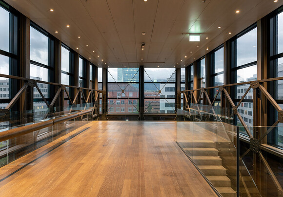 Interior of modern building with smart glass windows from left to right overlooking the city. 