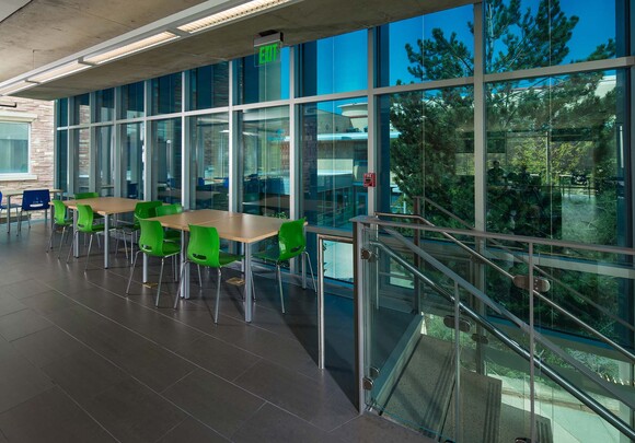 Office interior with smart glass windows looking over view of the landscape. 