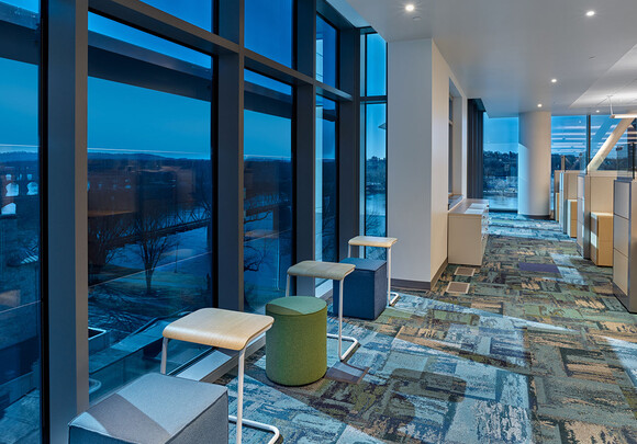 Office space in building with floor to ceiling smart glass windows. 